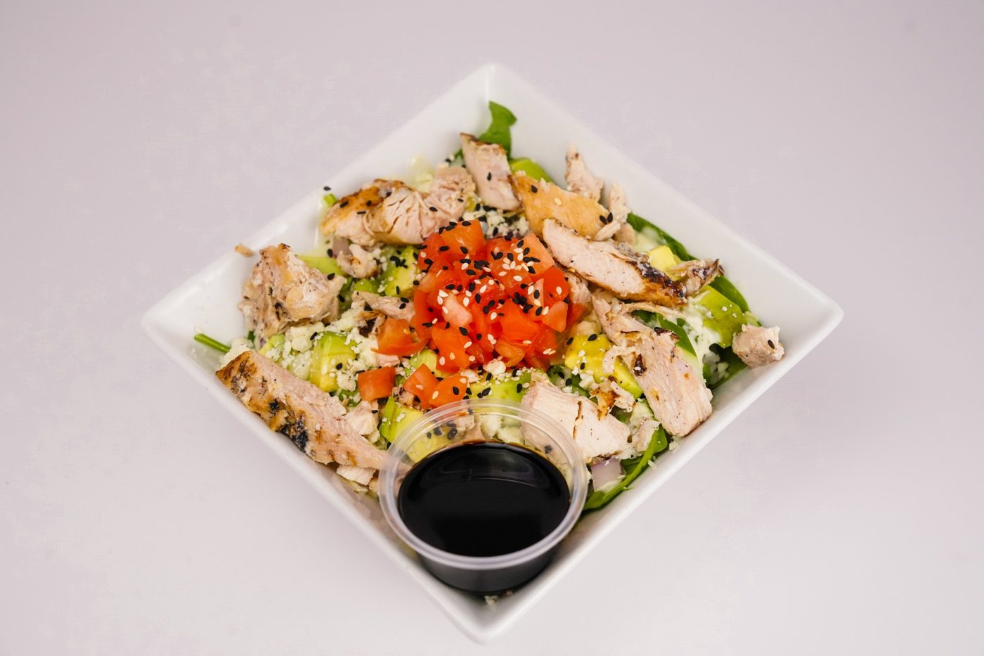 Grilled chicken salad with avocado, tomato and feta